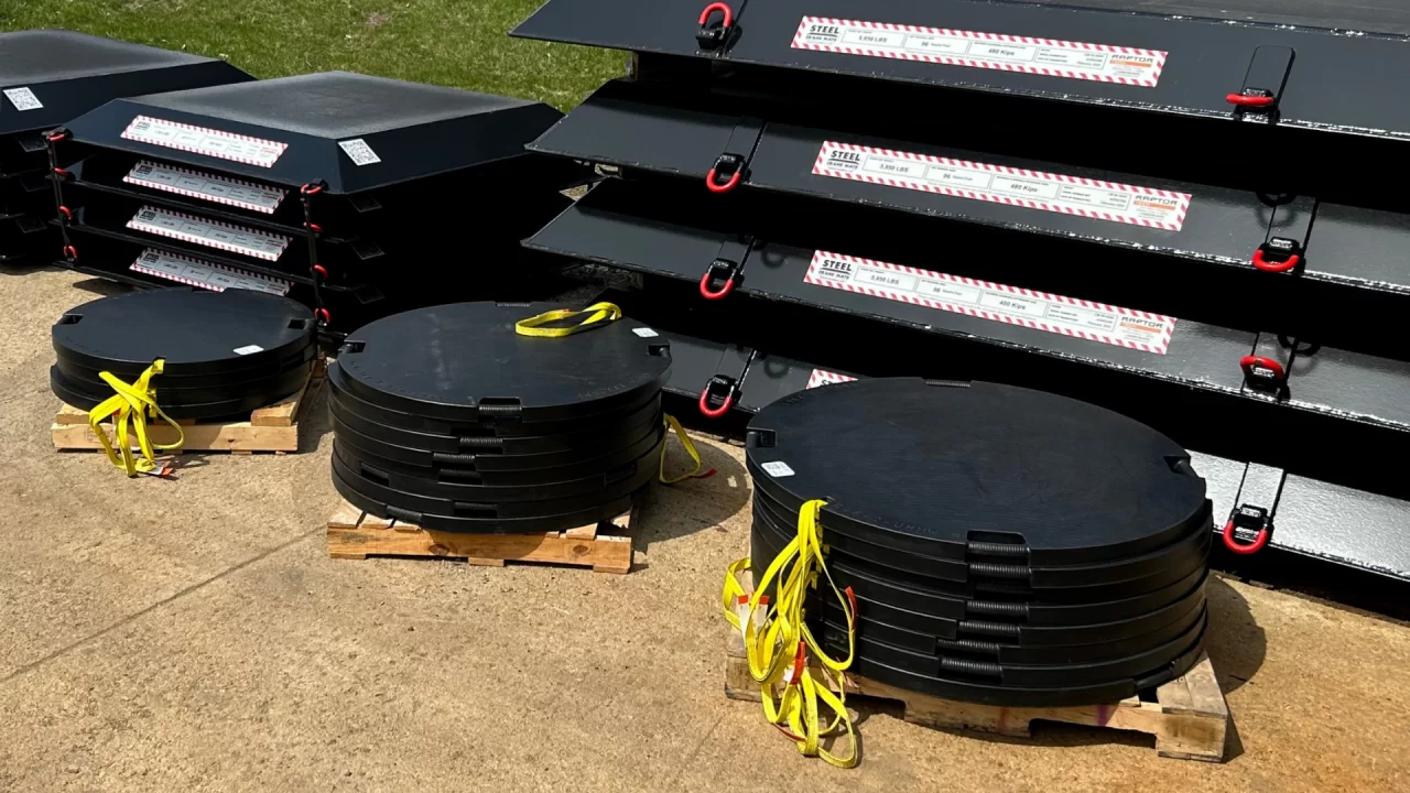 raptor tech premium outrigger pads with lifting lanyard near steel crane mats