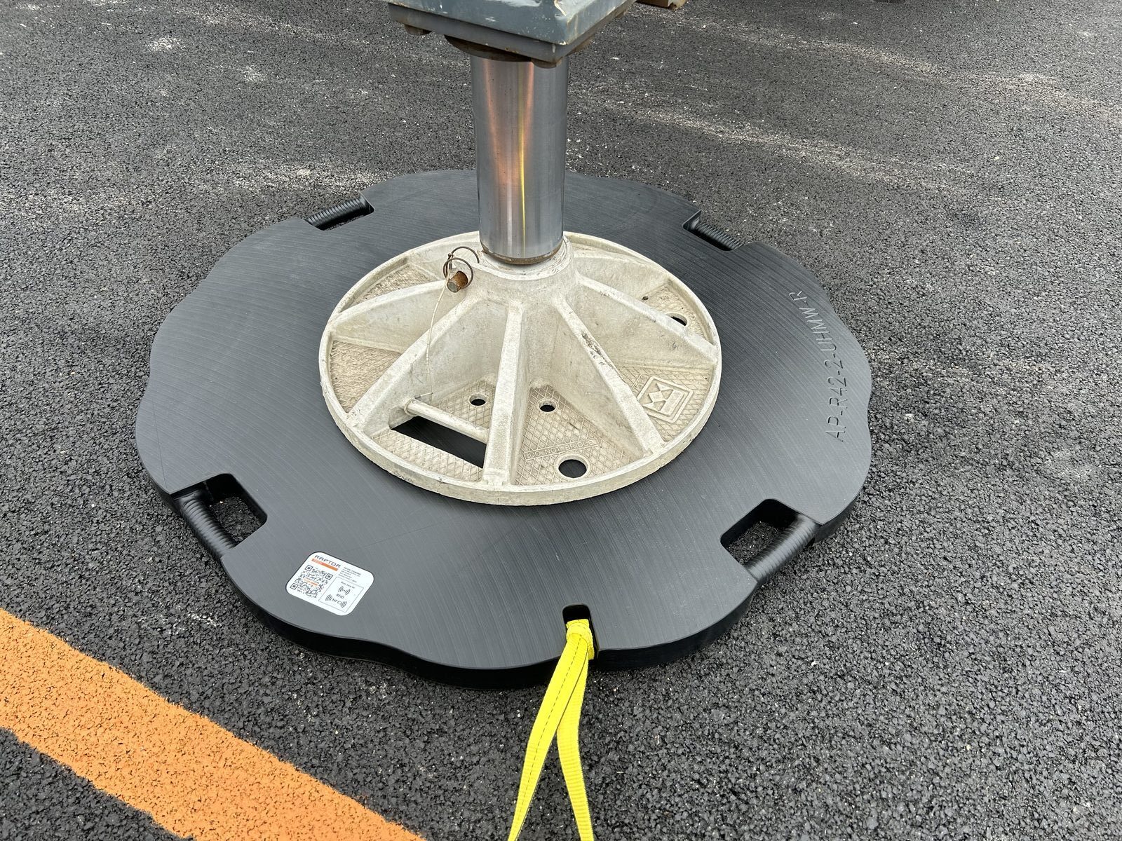 Raptor Tech Area Plus outrigger pad with contoured edge under a crane outrigger float